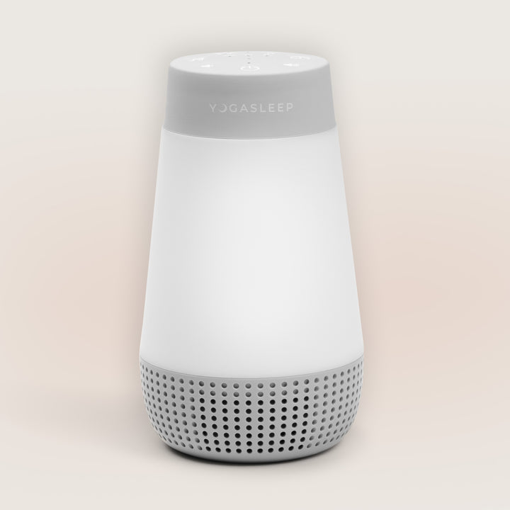 Front view of Travel-Friendly Baby Soother showcasing its speaker grille and white tapered body against a light background