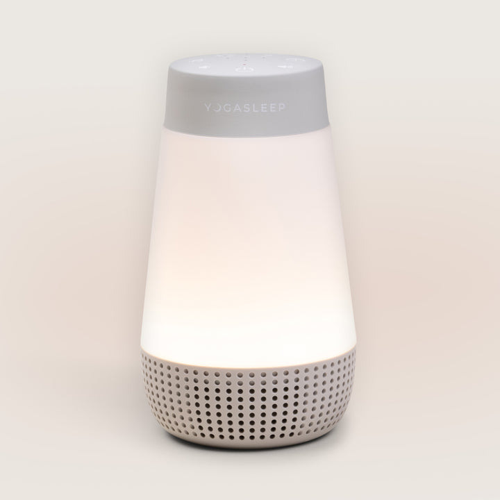 Front view of Travel-Friendly Baby Soother showcasing its glowing night-light and speaker grille against a light background