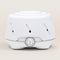 Dohm - A White sound machine with a ribbed texture and a circular switch.