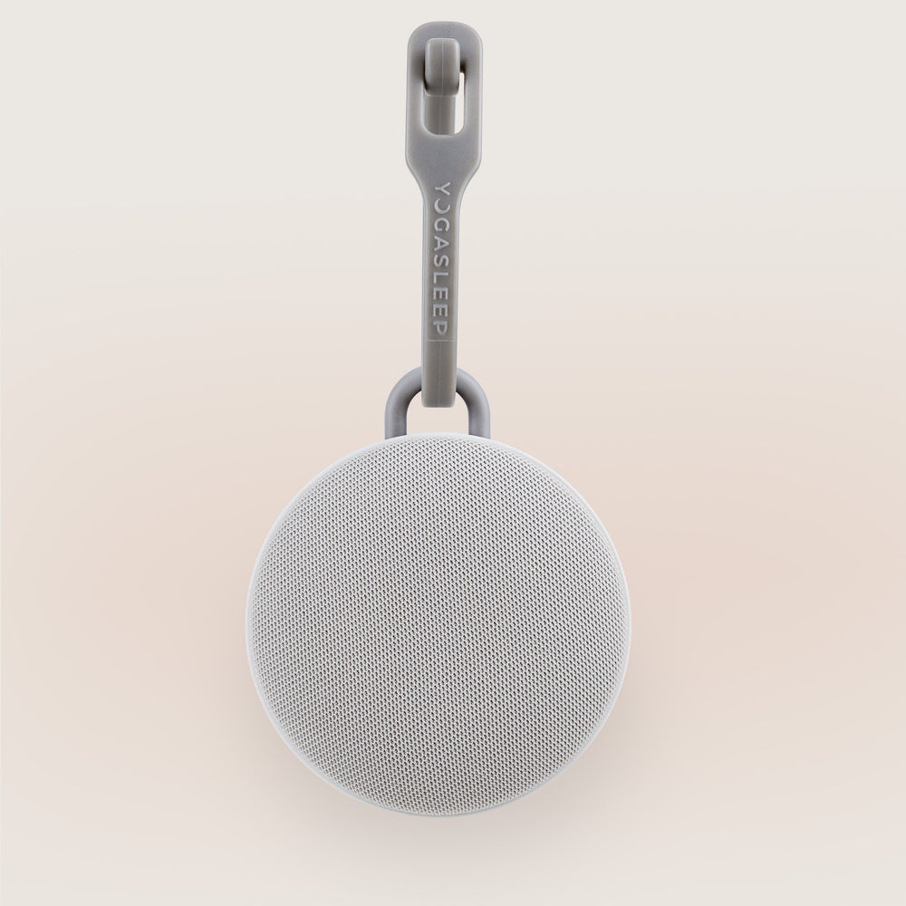 Hushh 2 - A white mesh speaker hangs from a gray carabiner with the YOGASLEEP logo.