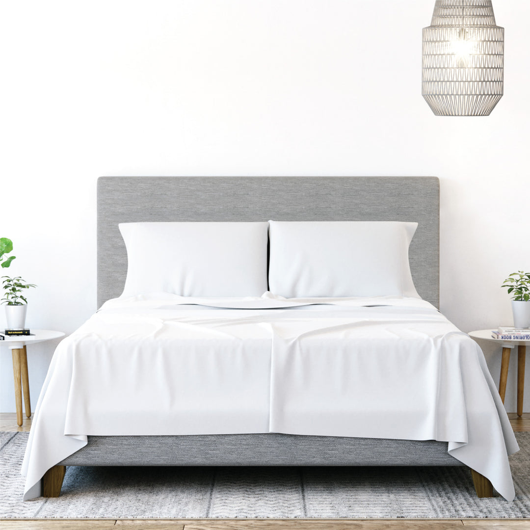 Front view of Yogabed Essential Sleep Bundle showcasing white sheets and pillows with a bright bedroom background