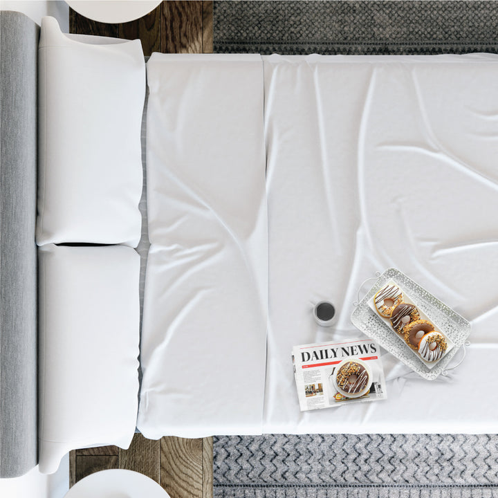 Overhead view of Yogabed Essential Sleep Bundle showcasing white bedding and pillows on a bed