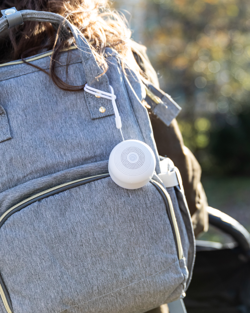 Portable sound machine attached to travel luggage