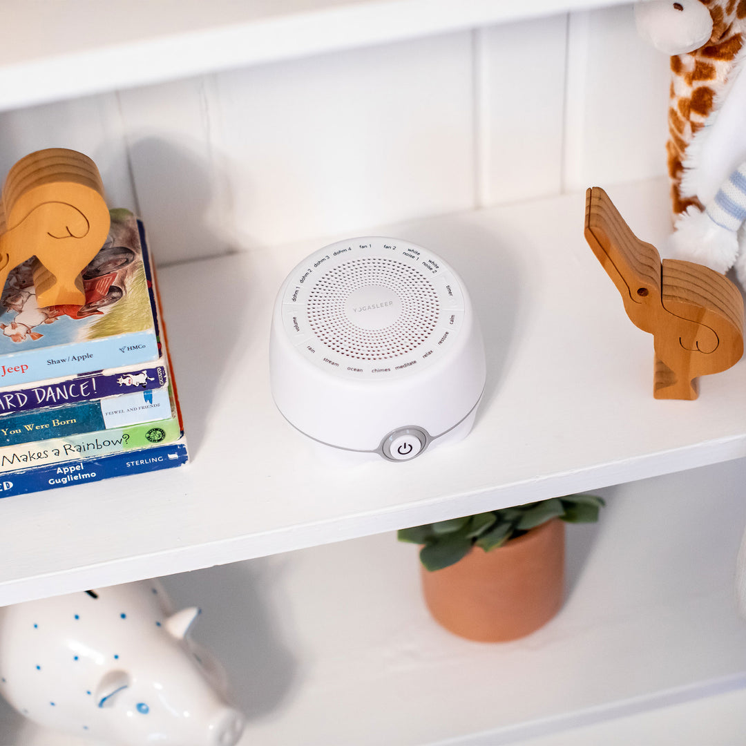 White Whish multi sound machine displayed on a nursery shelf with books, toys, and a potted plant